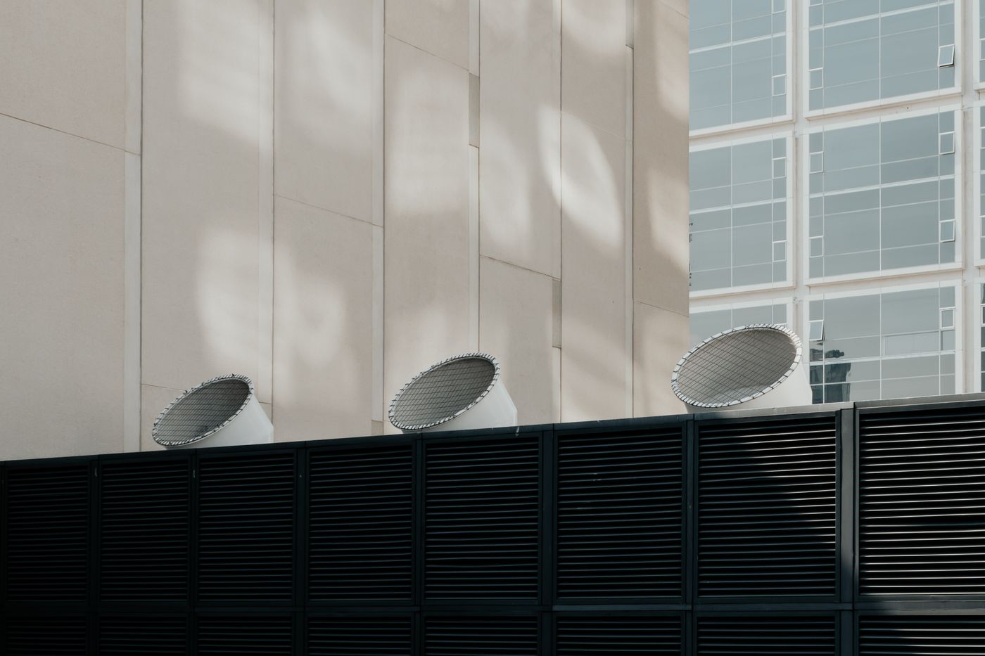 Rooftop ventilation plant beside a modern glass office building